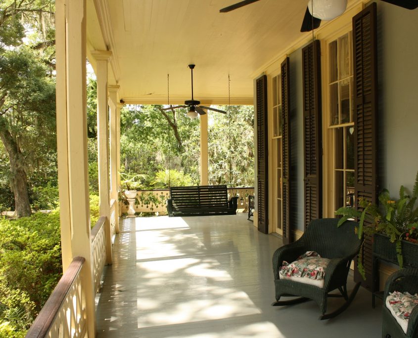 front porch with furniture on a sunny day - mortgage broker - real estate loans
